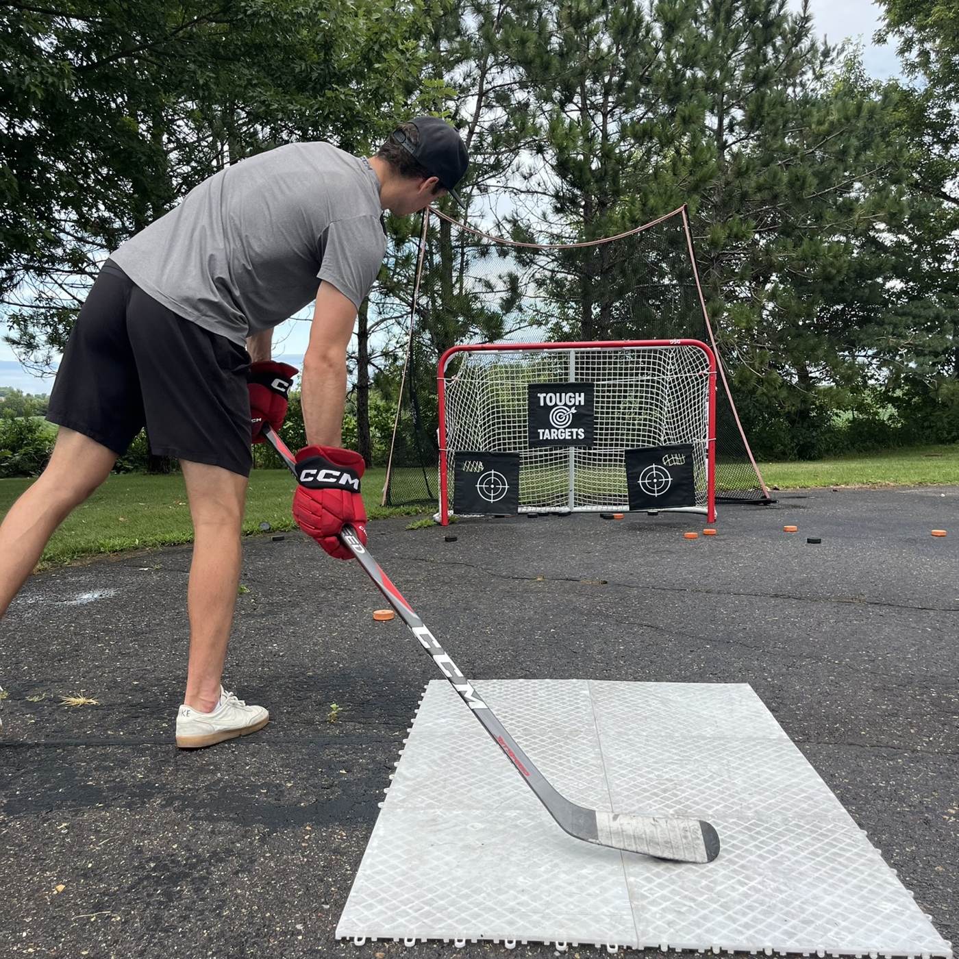 Player lining up a shot at a Tough Targets net in a driveway