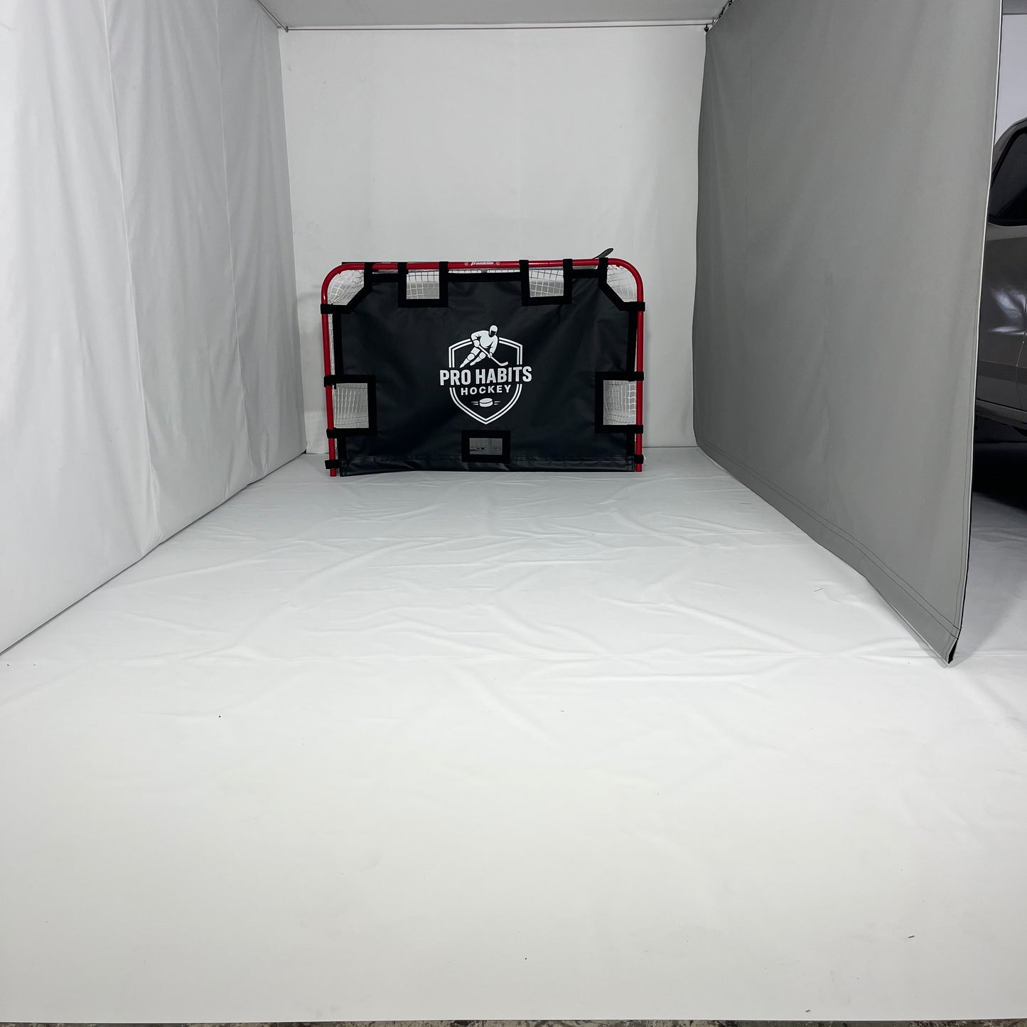 Protective sports curtain set up inside a garage