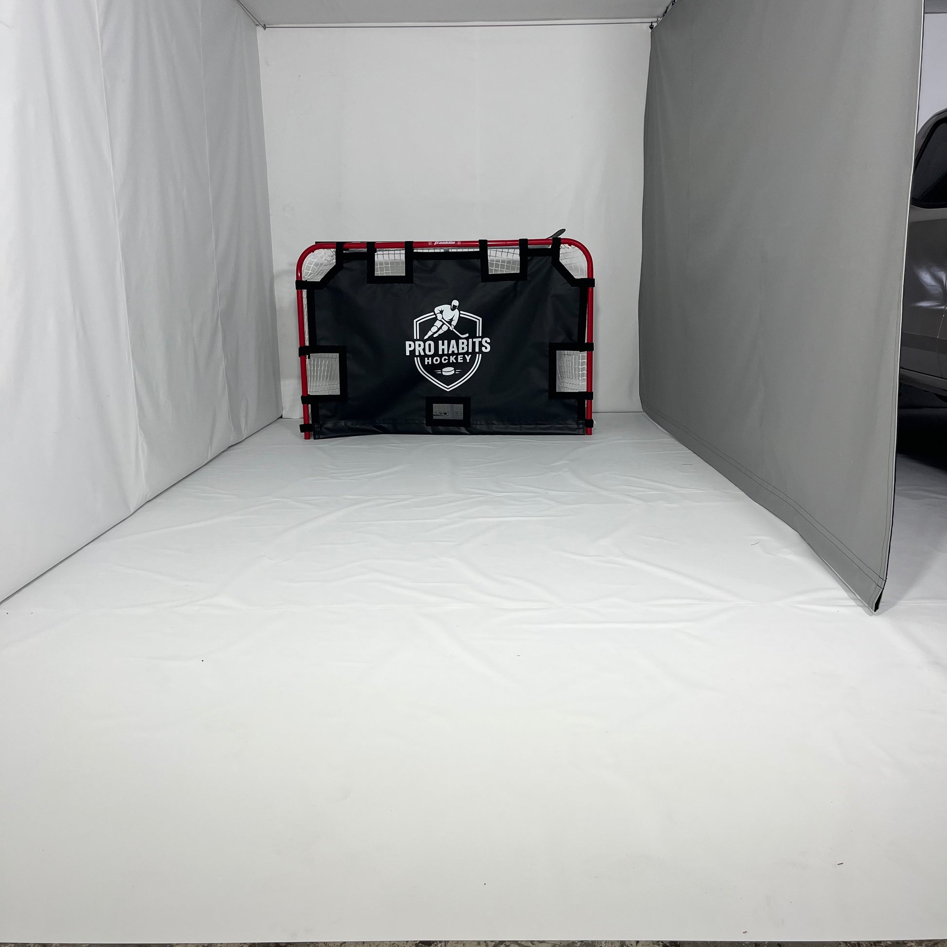 Protective sports curtain set up inside a garage