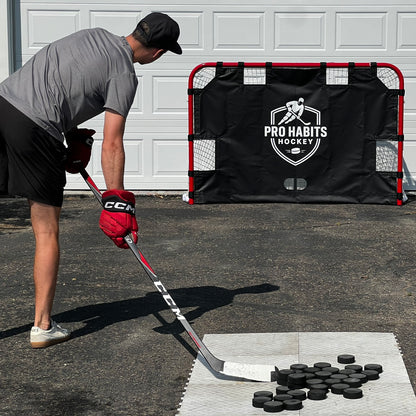 Player lining up a shot at the Pro Habits Hockey Heavy Duty Shooting Tarp on a hockey net in a driveway