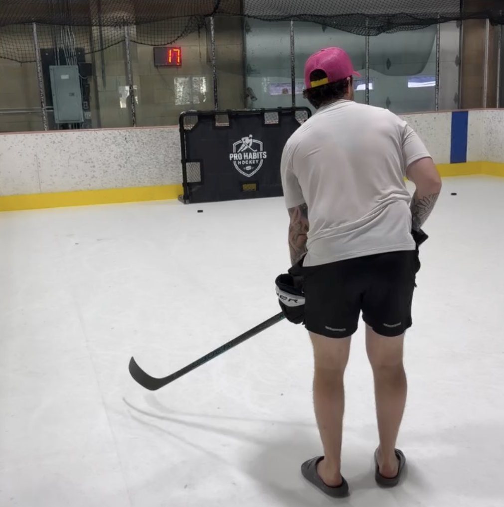 Player at a training facility shooting at a Pro Habits Hockey shooting tarp